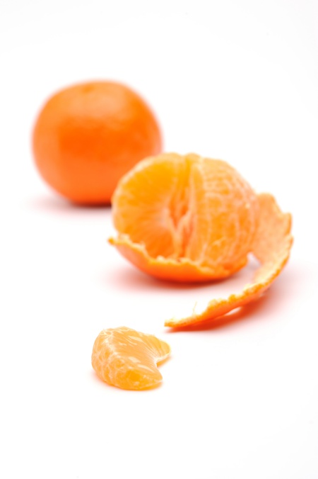Half-peeled tangerine on a white background