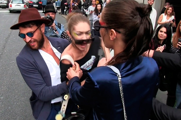 Bella and Gigi Hadid leave the Max Mara event in Milan, posing for photos with fans and smiling for the cameras. As the stunning duo made their way to their car, a crazy male fan approached Gigi from behind, picking her up off the crowd and attempting to carry her before the fiesty model fought back and sent the man running for his life. September 22, 2016 X17online.com NORTH AMERICA ONLY